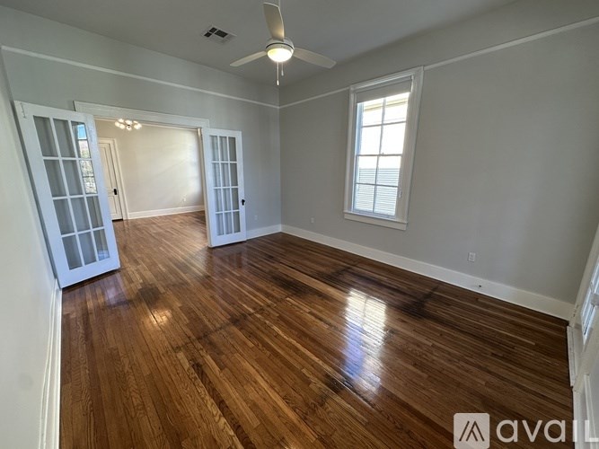 A room with wooden floors and a window.