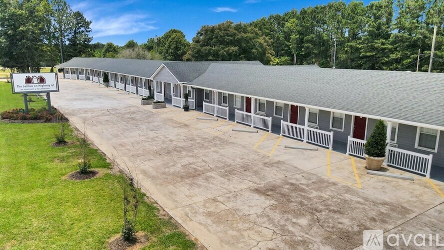 A row of houses with a sign that says "AVAILABLE" in front of them.