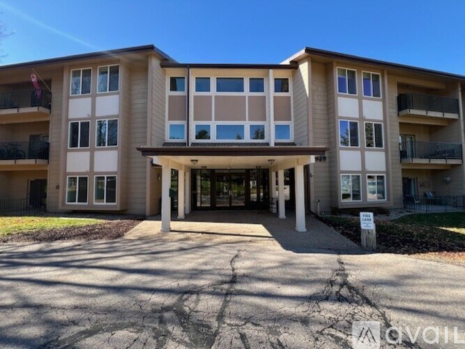 A large apartment building with a sign in front of it.