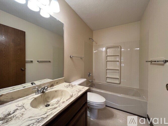 A bathroom with a marble countertop and a walk-in shower.