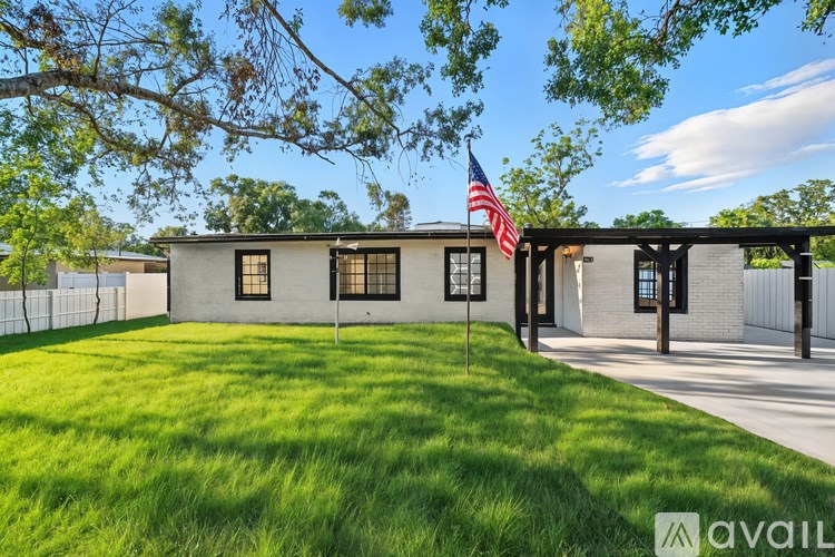 A house with a flag on the lawn.