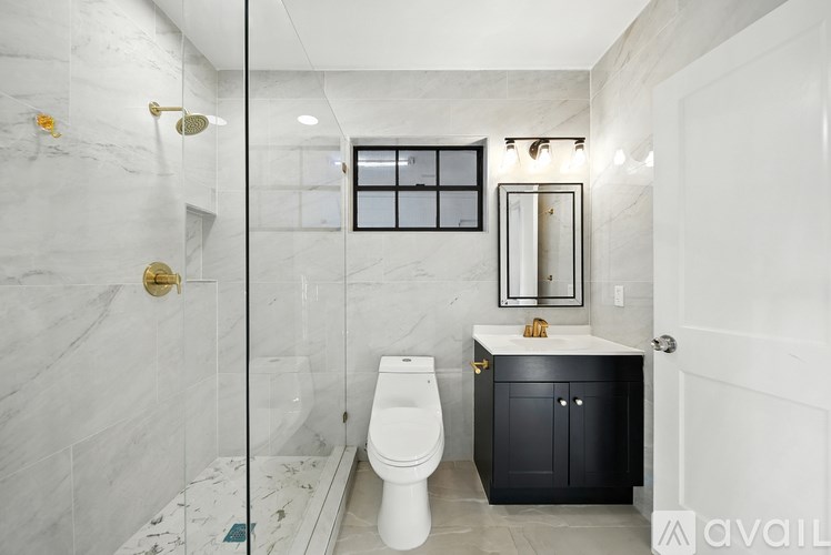 A bathroom with a toilet, sink, and shower.