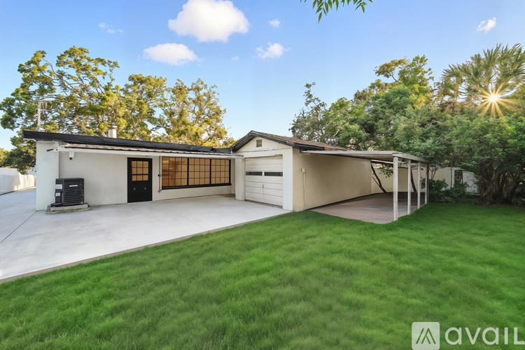A modern house with a large front yard and a garage.