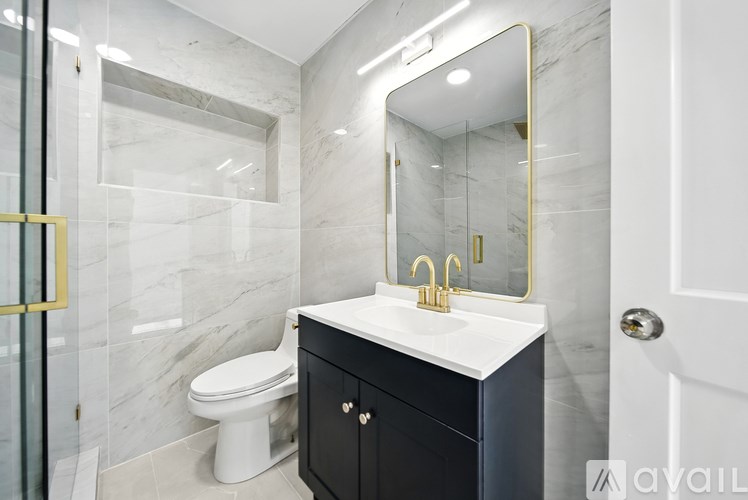 A bathroom with a white sink and a toilet.
