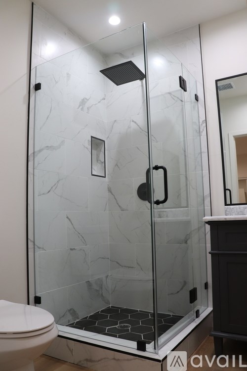 A bathroom with a walk-in shower and a toilet.