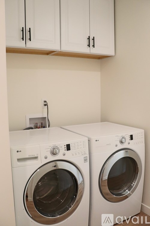 Two front load washing machines in a laundry room.