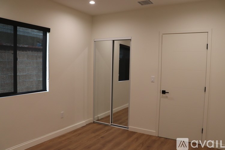 A room with a white door and a glass door.