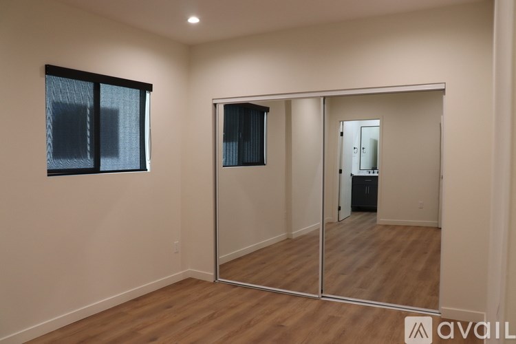 A room with a mirror and a window.