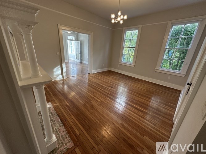 A room with wooden floors and white walls.