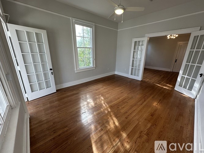 A room with wooden floors and white walls.