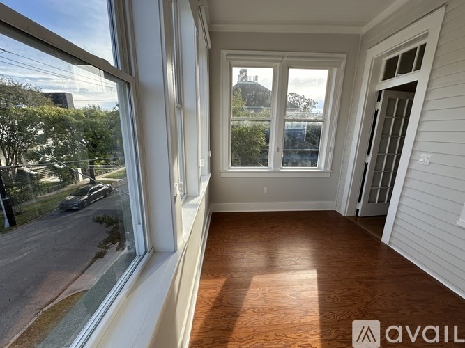 A room with a view of the street through the windows.