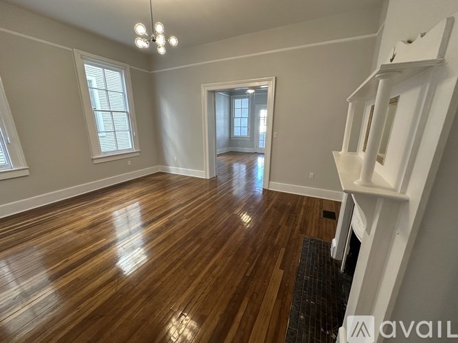 A room with wooden floors and white walls.