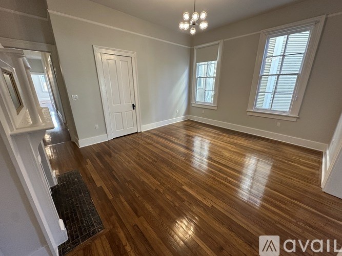 A room with wooden floors and a white door.