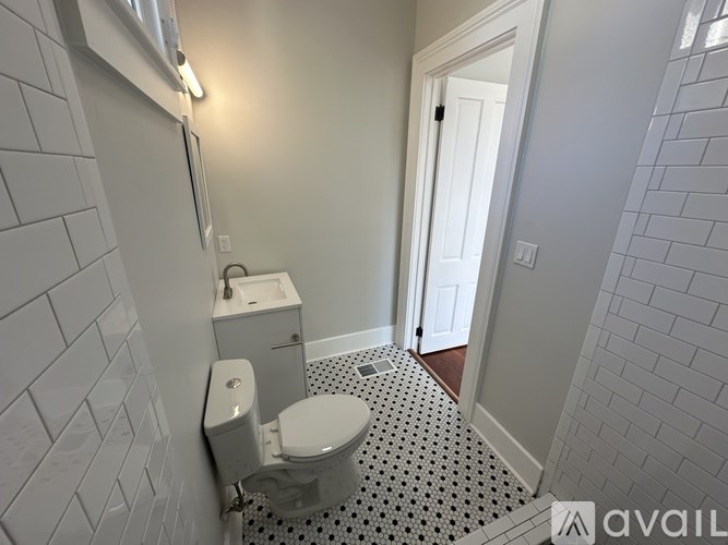 A bathroom with a toilet and a sink.