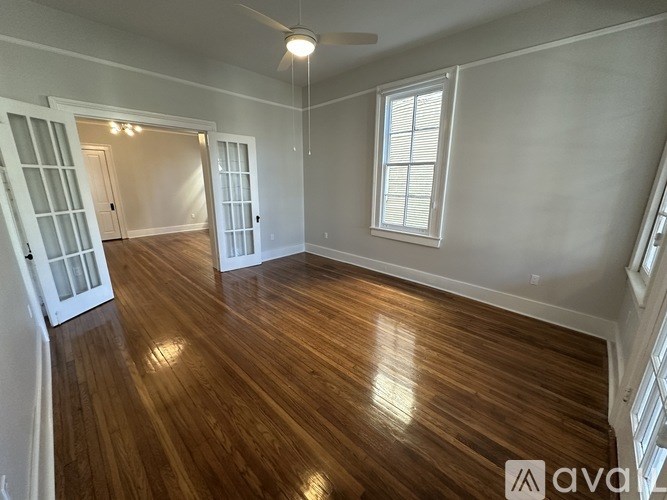 A room with wooden floors and white walls.