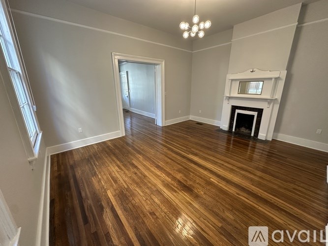 A room with wooden floors and a fireplace.