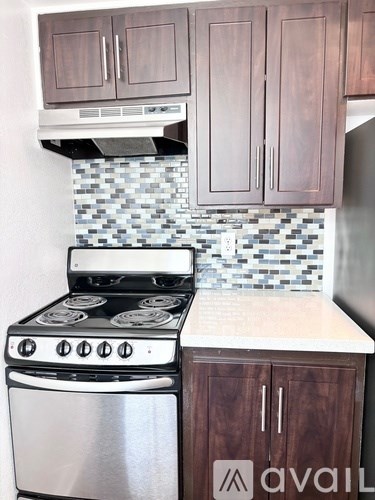 A kitchen with a stove and cabinets.