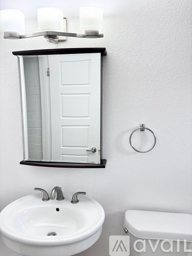 A white sink and toilet in a bathroom.
