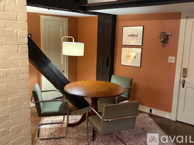 A room with a round table and chairs.