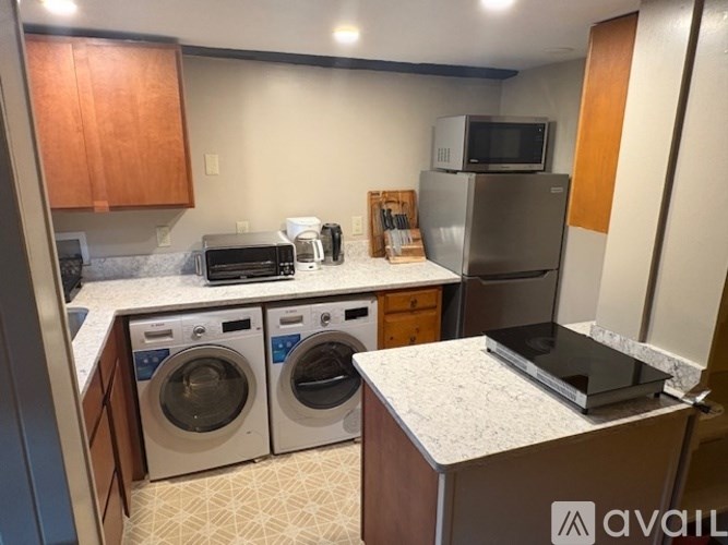 A kitchen with a washer and dryer in it.