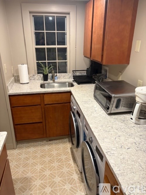 A kitchen with a washer and dryer in it.