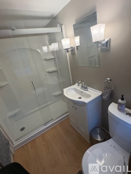 A bathroom with a sink, toilet, and shower.