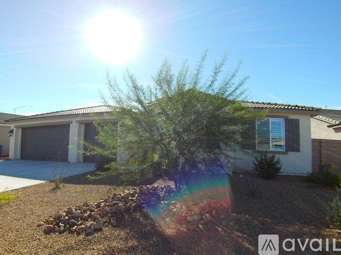 A house with a sunny sky above it.