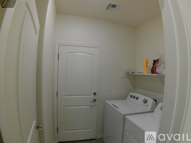 A small laundry room with a washer and dryer.