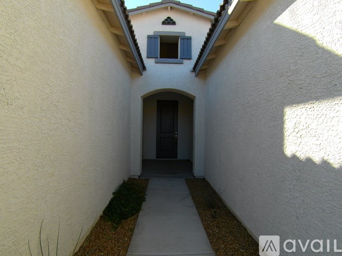 A white building with a small window and a doorway.