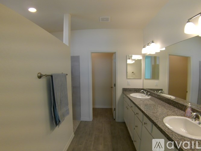 A bathroom with a sink, mirror, and towel rack.