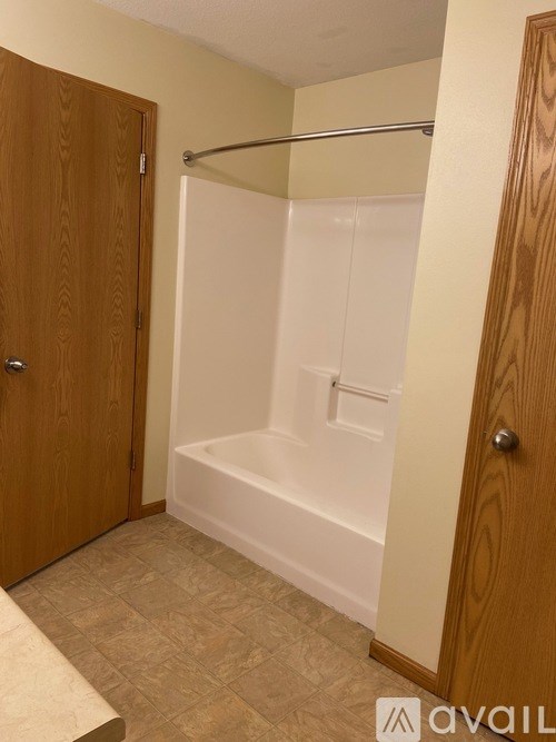A small bathroom with a towel rack and a bathtub.