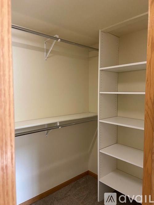 A white closet with a sliding door and shelves.