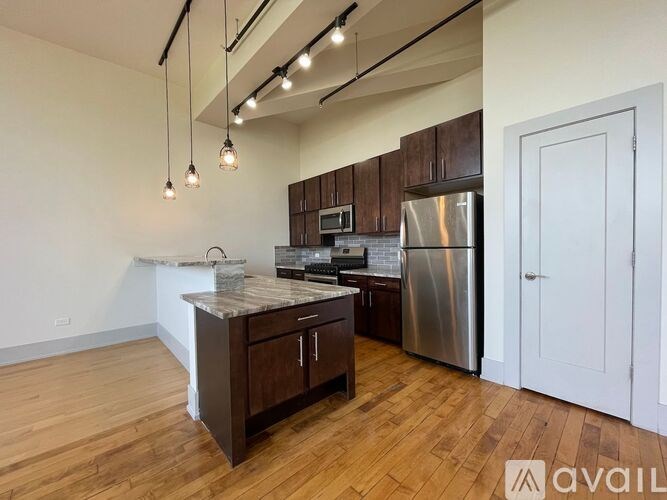 A kitchen with wooden floors and a marble countertop.