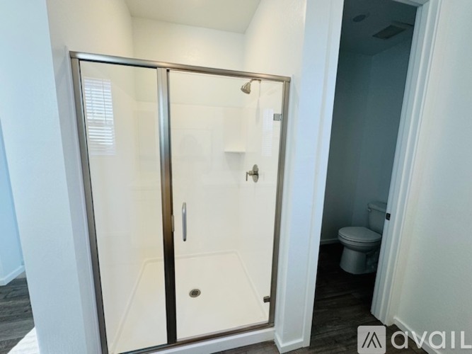 A white bathroom with a walk-in shower.