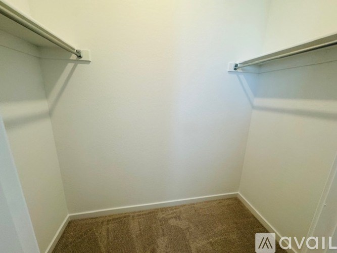 A small, empty room with a carpeted floor and white walls.