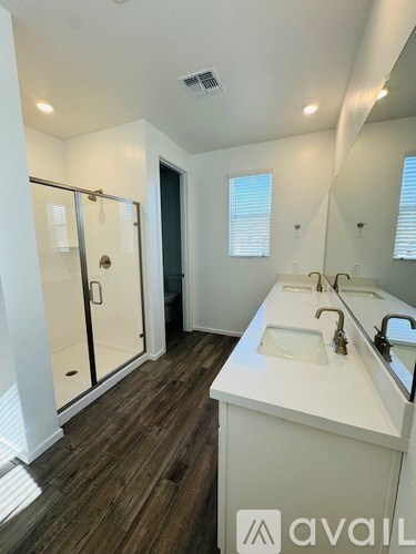 A bathroom with a white sink and a mirror.
