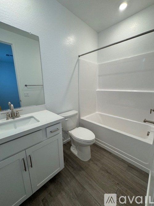 A bathroom with a toilet, sink, and bathtub.