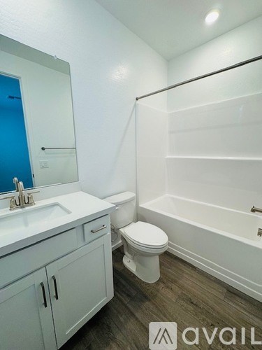 A bathroom with a toilet, sink, and bathtub.