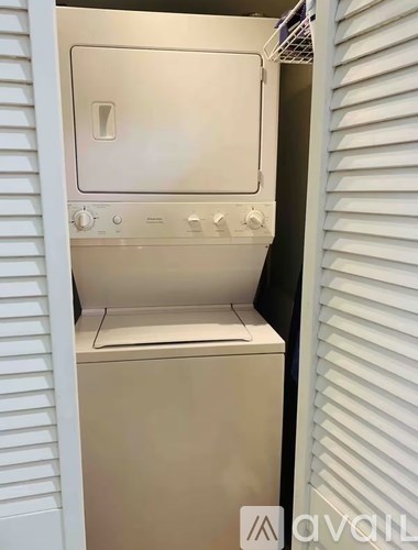 A white oven with a door open is in a kitchen.