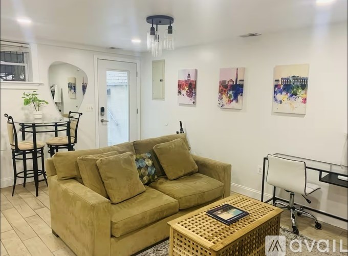 A living room with a tan couch and a coffee table.