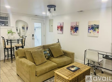 A living room with a tan couch and a coffee table.