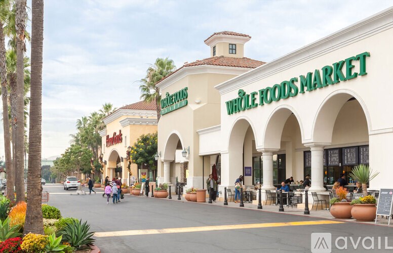 A Whole Foods Market store with people walking by.
