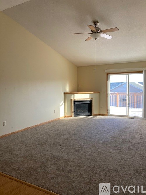 A room with a fireplace and a ceiling fan.