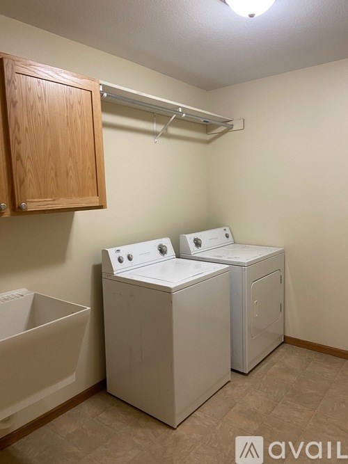 A small laundry room with a washer and dryer.