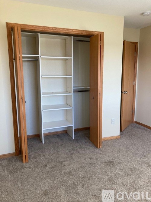 A large open closet with shelves and a door.
