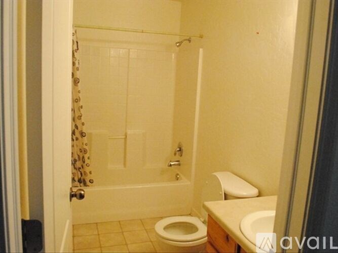 A bathroom with a toilet, sink, and shower.