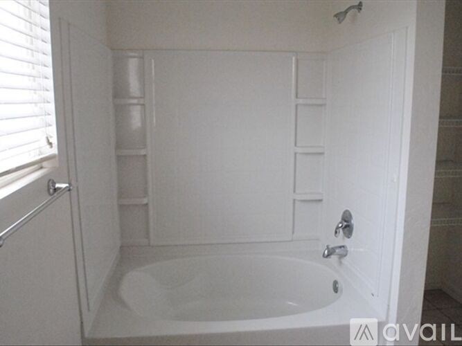 A white bathroom with a tub and a shower.