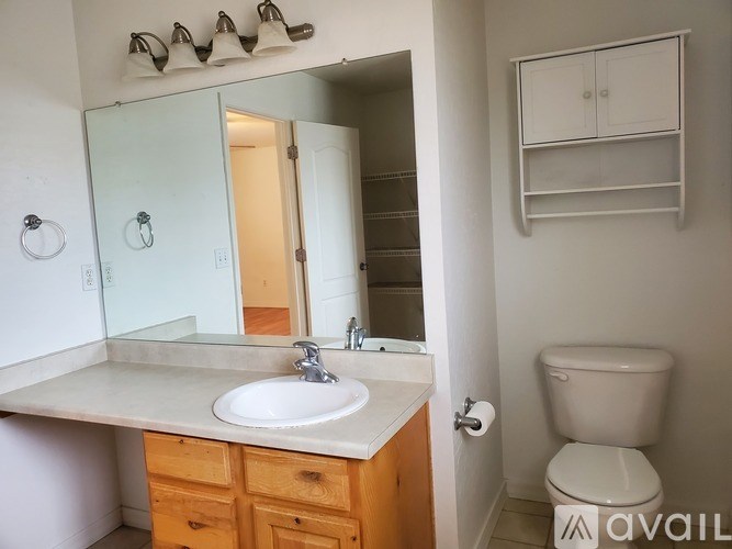A bathroom with a sink, toilet, and medicine cabinet.