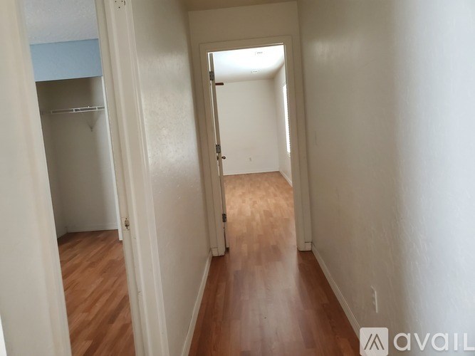 A hallway with a door at the end.