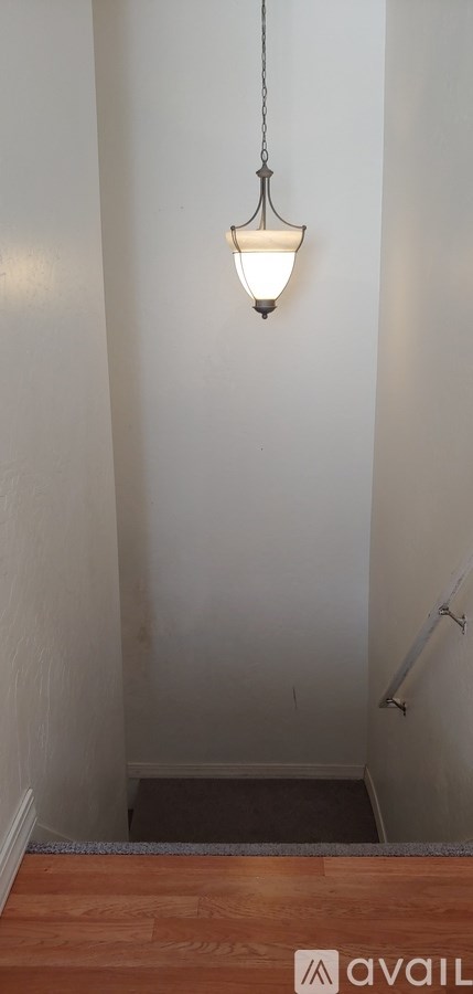 A lamp hanging from a ceiling in a room.